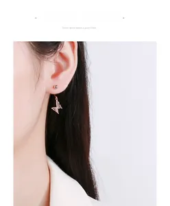 Close-up of rose gold hollow butterfly stud earrings in 925 sterling silver on ear