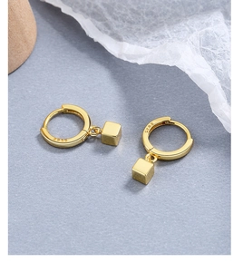 Detail of S925 sterling silver stamp on minimalist gold cube pendant earrings