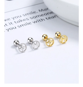 Detail of 925 silver star and letter H earrings with gold and silver threaded ball backings