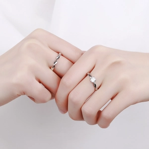Sterling silver Mobius couple rings set featuring a sparkling round cubic zirconia stone