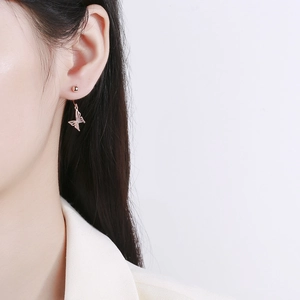 Elegant rose gold bow-shaped hollow drop earrings on model for a sophisticated look