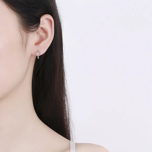 Hollow heart-shaped 925 sterling silver earrings worn by a model in a close-up shot