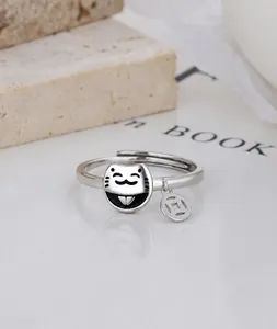 Detail of 925 silver lucky cat ring with coin pendant and black enamel features