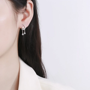 Elegant 925 silver star and moon tassel earrings with diamonds worn by a model