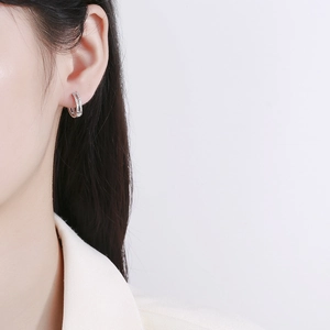 Double-layered 925 silver hoop earrings with shimmering zircons on elegant model
