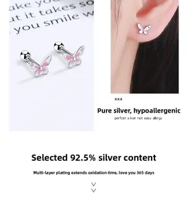 Macro detail of S925 sterling silver pink butterfly stud earrings with screw backs