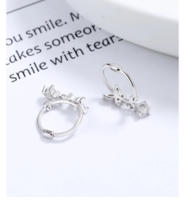 Macro shot of S925 sterling silver stamp on bow earrings with zircon stones