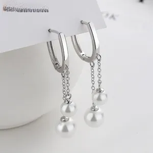 Detailed view of 925 sterling silver chain earrings with elegant double white pearls