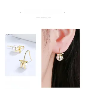 Detail of S925 sterling silver bow pearl earrings with model wearing for style