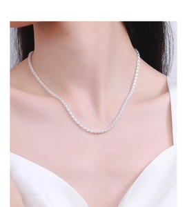 Detail of S925 sterling silver phoenix tail chain necklace worn on a female model neck