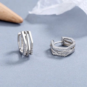 Detailed macro shot of S925 sterling silver triple-layer hoop earrings with white zircon