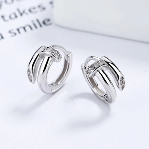 Detail view of 925 sterling silver hoop earrings with cubic zirconia in a triple hoop design