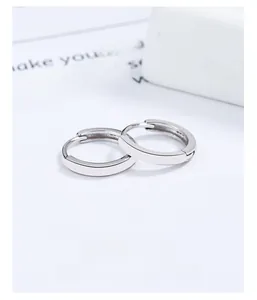 Close-up of minimalist 925 sterling silver hoop earrings on a decorative display card