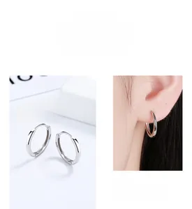 Detailed view of minimalist 925 sterling silver hoop earrings in gold and silver finishes