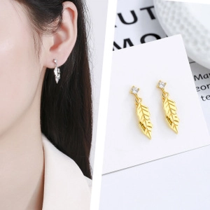 Detail of leaf-shaped earrings with fine vein textures and square sparkling gemstones