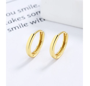 Close-up of golden S925 sterling silver hoop earrings with clear hallmark stamp