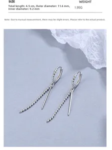 Detail view of long tassel rice grain earrings in silver with specific measurements