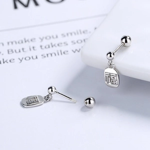 Detailed macro view of S925 sterling silver ball stud earrings with Fu character pendant