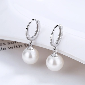 Elegant 925 silver teardrop pearl earrings with shimmering zircon accents on minimalist stand