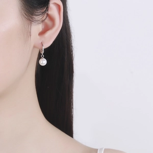 Elegant waterdrop pearl drop earrings with 925 sterling silver hooks on female model