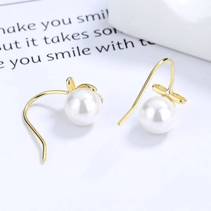 Elegant gold bow pearl drop earrings with 925 silver hooks on a clean white display