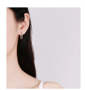 Close-up of chunky s925 silver hoop earring worn on ear with polished finish