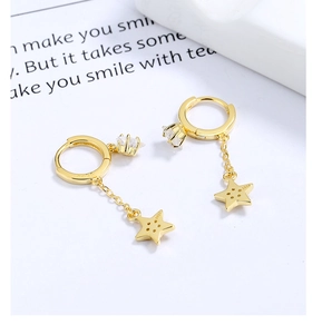 Macro detail of S925 sterling silver stamp on gold-plated star tassel earrings