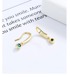 Close-up of S925 silver gold-plated dangle earrings with emerald green zircon stones