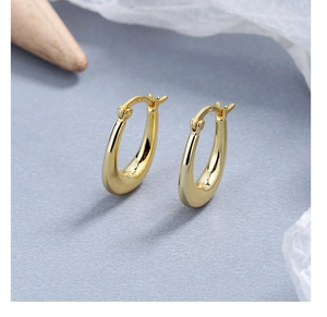 Macro shot of S925 sterling silver hallmark on the inner band of gold teardrop earrings
