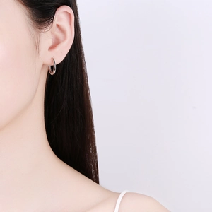 Minimalist 925 sterling silver hoop earrings for women with polished finish on model