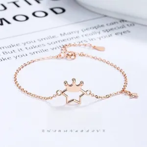 Detail of rose gold star and crown bracelet with adjustable chain and lobster clasp