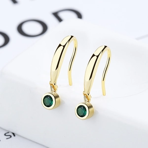Elegant gold drop earrings featuring a brilliant round emerald green gemstone inlay