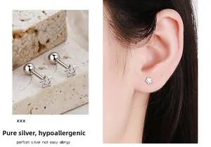 Macro detail of silver smile star stud earrings with secure ball screw back closure