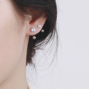 Detailed view of sterling silver oval geometric screw-back earrings and zircon studs set