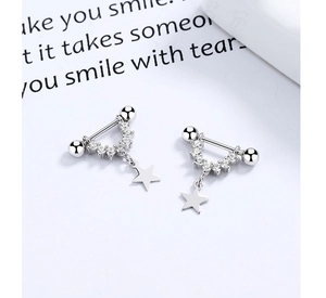 Detailed macro view of S925 silver U-shaped earring with zircon stones and star pendant