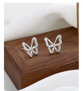 Macro shot of silver butterfly stud earrings with sparkling cubic zirconia inlay