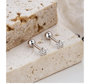 Macro shot of silver star stud earrings with smiley face design and ball screw back closure