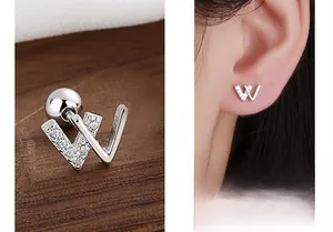 Macro detail of silver W-letter stud earring with zircons and screw ball back closure