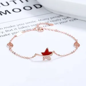 Close-up of maple leaf bracelet with red enamel and pavé cubic zirconia details