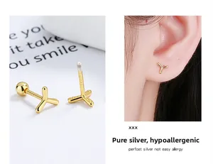 Macro detail of S925 sterling silver golden windmill stud earrings with screw back