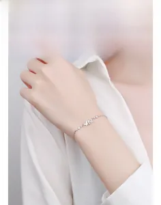 Detail of 925 sterling silver butterfly bracelet with sparkling diamonds on a wrist