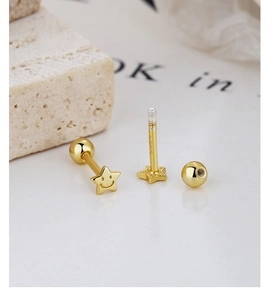 Detail shot of gold S925 sterling silver star stud earring with engraved smiley face