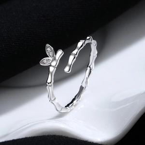 Detail shot of silver bamboo-style open ring with leaf-shaped sparkling accents