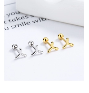 Macro detail of Y-shaped screw back earrings in gold and silver polished finishes