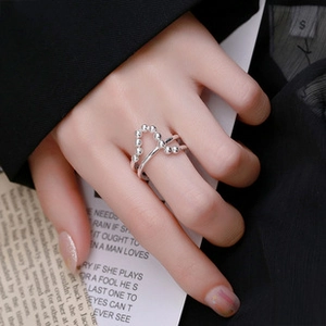 Detail of S925 silver double-layered crisscross ring with beaded and smooth bands