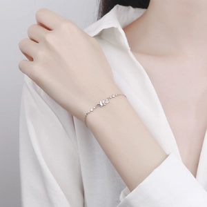 Elegant 925 sterling silver butterfly bracelet with crystal charms on a woman's wrist