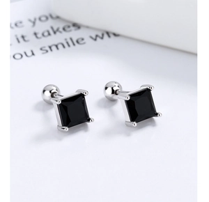 Macro view of square black zircon stud earrings with secure silver screw ball backs