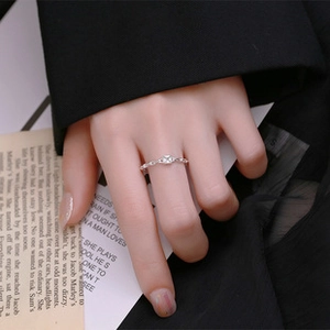 Detailed close-up of a 925 sterling silver bow knot ring worn by a model in soft light