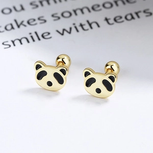 Macro shot of gold panda stud earrings with black enamel and secure screw back closure