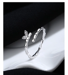 Macro shot of bamboo-shaped silver ring with sparkling crystal-inlaid leaves